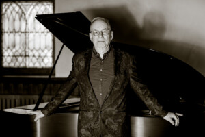 Andrew Levine in front of piano